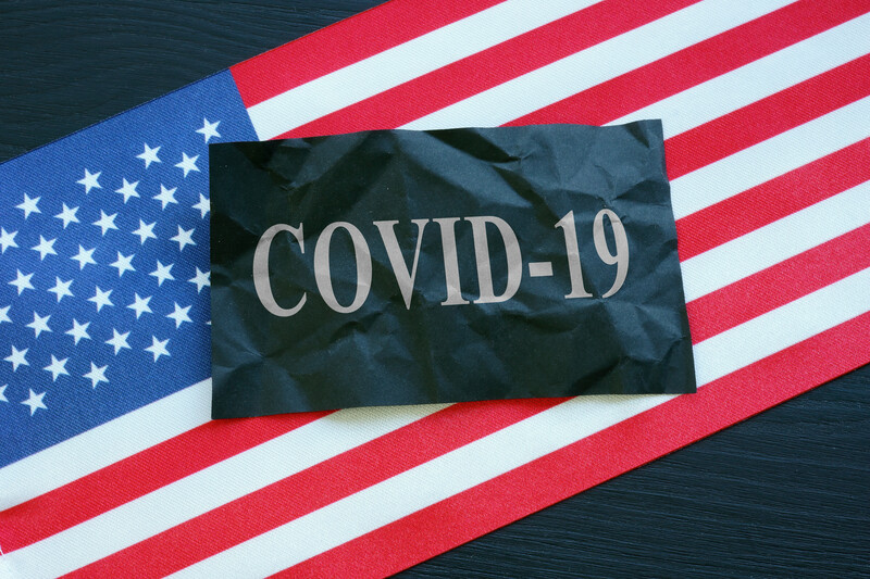 Black Covid-19 flag on top of US flag